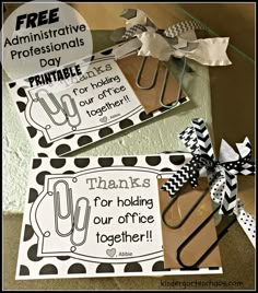 two black and white paper clips on top of each other with the words thank you for holding our office together