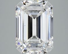 an emerald - cut diamond is displayed on a gray background, with the center stone visible