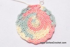 a crocheted ornament is hanging on a white surface with a string