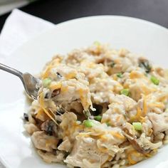 a white plate topped with chicken and rice casserole covered in gravy