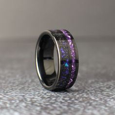 a wedding band with purple and black glitter inlays