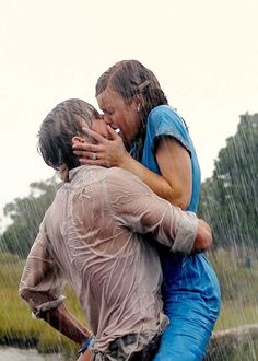 two people in the rain hugging each other