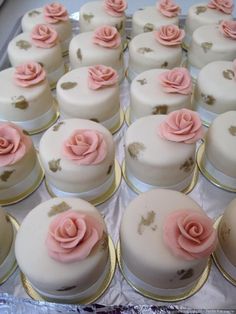 there are many small cakes with pink flowers on them