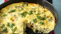 an omelet is shown in a cast iron skillet with one piece missing