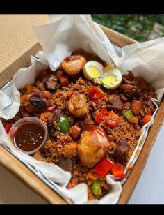 a box filled with rice, meat and veggies