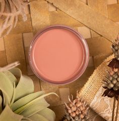 a close up of a pink substance in a bowl next to some pineapples