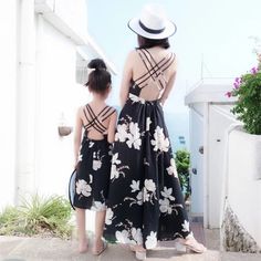 Beautiful Mommy & Me Matching black spaghetti strap dresses with beautiful all over white floral print. Criss-cross strappy back. Perfect for special occasions, events and beach days! Momma's sizes: S-L. Girls' sizes: 24M-14Y. Good things take time. Quicker shipping: this dress ships directly to you from our overseas warehouse, and will arrive in approximately 7-10 business days. Black Spaghetti Strap Dress, Flora Dress, Things Take Time, Black Spaghetti, Black Spaghetti Strap, Strap Dresses, Good Things Take Time, Beach Days, Take Time