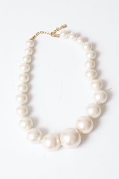 Chunky, oversize faux pearl necklace with gold clasp. Material: Faux Pearl Rating: 9/10 - Nearly new. No signs of wear. MEASUREMENTS Length: 16 inch strand FINAL SALE. This item is not returnable. If returned to us, it will not be refunded, credited, or returned back to the customer. No adjustments to prior markdowns. For product inquiries please contact shop@consignmentbrooklyn.com. Affordable Pearl White Round Bead Necklaces, Cheap White Statement Pearl Necklace, Affordable Handmade White Necklace, Affordable Beaded Pearl White Necklace, Affordable White Beaded Pearl Necklace, Cheap Vintage Pearl White Necklace, Cheap Cream Necklaces With Round Beads, Pearl Necklace With Gold, Faux Pearl Necklace