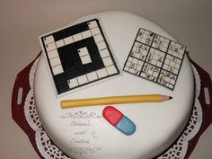 a cake decorated with an image of a crossword puzzle, pencil and eraser