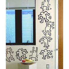 a room with a door, window and wall sticker on the wall in it