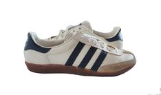 Vintage Adidas Univerzal sneakers produced in Yugoslavia in the 70's/80's. White leather with black and stripes. Size US mens 4.5, EU 37. Mint condition. Still elastic sole. Sterilized and clean. Rare and collectible. Adidas Vintage Shoes, Vintage White Adidas Sneakers, Vintage Adidas Shoes, Retro Adidas Sneakers With Logo, Vintage White Leather Skate Shoes, Old Adidas, 70s Sneakers, Vintage Sports Sneakers With Three Stripes, Adidas Shoes 1988