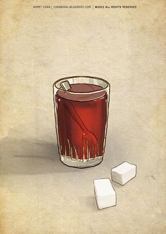 a glass of red liquid next to cubes of ice