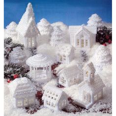 a snowy village with white houses and trees