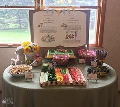 a table topped with lots of candy and candies next to a sign that says baby shower