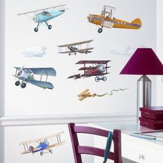 an airplane wall decal in a child's room with other planes on the wall