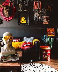 a living room filled with furniture and pictures on the wall next to a busturine