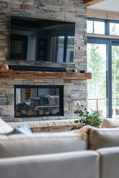 a living room with couches and a flat screen tv mounted on the wall above a fireplace