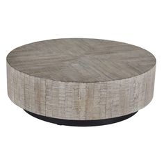 a round wooden table sitting on top of a white floor