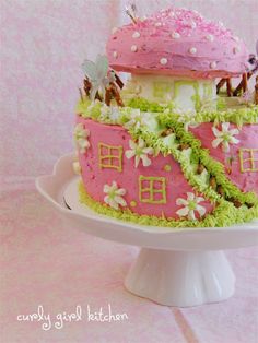 there is a cake that has been decorated with pink and green icing on it