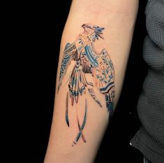 a woman's arm with a tattoo on it that has a bird in flight