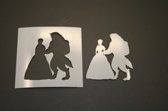 some cut out paper with the silhouettes of two people and a princess on them