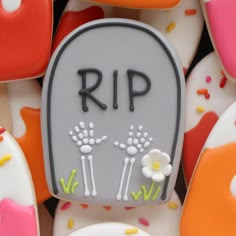 a tombstone with flowers on it surrounded by sprinkles and frosted cookies