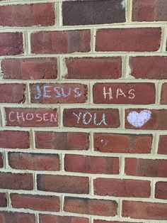 graffiti written on the side of a brick wall that says jesus has chosen you,