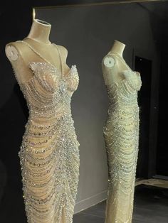 two mannequins dressed in evening gowns with beading