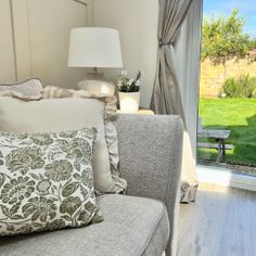 a living room filled with furniture and a sliding glass door leading to a lush green yard