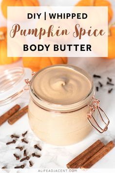 pumpkin spice body butter in a glass jar surrounded by cinnamons and cloves