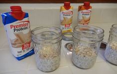 four jars filled with oatmeal sitting on top of a counter