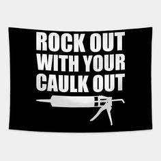 rock out with your caulk out sign on a black and white wall hanging