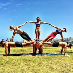 a group of women doing yoga poses in a park on their stomachs and arms