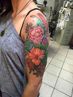 a woman with a flower tattoo on her arm