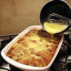 a pan filled with food sitting on top of a stove next to a burner