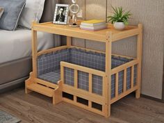 a bed with a wooden frame next to a night stand and a plant on top of it