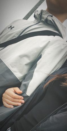 a person with their hand on the back of a jacket that's attached to them