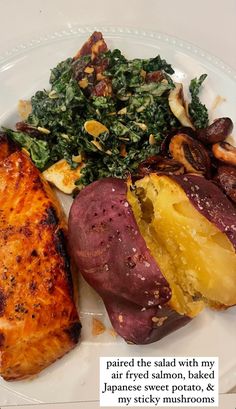 a white plate topped with meat, potatoes and veggies next to a salad