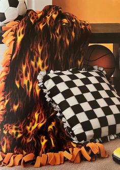 a black and white checkered blanket sitting on top of a chair next to a soccer ball