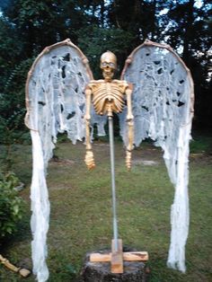 a fake skeleton with wings is in the grass