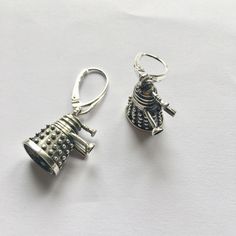 "EXTERMINATE Handmade silver Dalek Earrings - inspired by the one and only Doctor Who. This is 925 sterling silver, 100% free from Nickel (Ni) so if you are nickel allergic you will not react to this. The surface is treated with oxide for a \"greyish\" look. These are quite heavy earrings and should be worn with a little care so you don't hurt your ears. :) NOTE!! The style of the attachments can vary! Please let me know if you have any preferations. Weight: ~6 g Height: ~18 mm Width: ~11-12 mm Handmade Themed Sterling Silver Jewelry, Silver Themed Earrings As A Gift, Themed Sterling Silver Jewelry In Silver, Nickel-free Silver Themed Jewelry, Obi Wan Lightsaber, Doctor Who Jewelry, Heavy Earrings, Wibbly Wobbly Timey Wimey Stuff, Timey Wimey Stuff