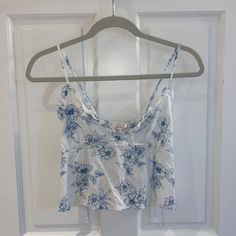 This Blue And White Flower Patterned Tank Top Was Purchased At Pacsun. It Is New With Tags And Includes Adjustable Straps And An Elastic Back. Blue Floral Print Beach Tops, Blue Floral Print Tops For Vacation, Blue Floral Print Top For Day Out, Blue Floral Print Tops For Day Out, White Summer Tops With Floral Print, Blue Floral Print Summer Top, Light Blue Floral Print Vacation Tops, White Floral Print Summer Top, Summer White Floral Print Tops