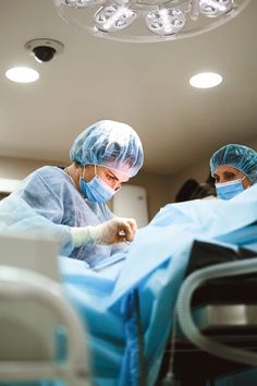 two surgeons are performing surgery in an operating room