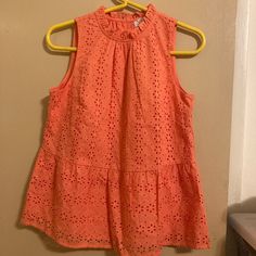 Cute Summery Sleeveless Shirt In Coral. Eyelet Peplum Shirt With Ruffled High Neckline. Inner Lining. Brand New, Never Worn, Tag Still On. Perfect With A White Pair Of Shorts Or Denim Jeans. Nwt. Orange Sleeveless Cotton Tank Top, Orange Cotton Sleeveless Tank Top, Orange Sleeveless Tank Top For Spring, Chic Orange Sleeveless Blouse, Summer Orange Sleeveless Blouse, Orange Sleeveless Cotton Top, Orange Camisole Tank Top For Spring, Orange Sleeveless Top For Spring, Orange Sleeveless Casual Blouse