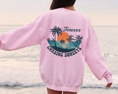 Forever Chasing Sunsets Sweatshirt or Hoodie Two Side Printed, Retro Beach Sweater, Tropical Tee, Retro Summer Sweatshirt, Aesthetic Summer This shirt has a hand pressed design. It has a very soft touch that you will feel comfortable for a long day. HOW TO ORDER ** Check and Review all Photos. ** Select your item's Size and Color from drop down menus. ** Choose the Quantity you want. ** Provide personalization in personalization box if offered.(name, print color etc.) ** Click ADD TO CART. And, Beach Season Streetwear Sweatshirt Crew Neck, Vsco Crew Neck Sweatshirt For Summer, Vsco Style Crew Neck Sweatshirt For Summer, Summer Vacation Hoodie With Crew Neck, Beach Season Graphic Print Long Sleeve Sweatshirt, Long Sleeve Graphic Sweatshirt For Beach Season, Long Sleeve Graphic Print Sweatshirt For Beach Season, Long Sleeve Tops For Beach Season Streetwear, Vsco Style Long Sleeve Sweatshirt For Vacation