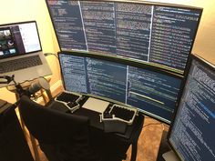 three computer monitors sitting next to each other in front of a laptop on a desk