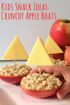 an apple filled with cereal and some cheese on top of it next to other apples