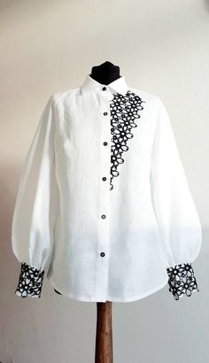 "Linen Blouse of a semi-adjacent silhouette.   - Back with middle seam - Puff sleeves  - Wide cuff, fastened with 2 buttons - The neck is finished with a stand-up collar - Optionally, the model can be decorated with white or black lace on the left half of the front and on the cuffs. SIZE CHART: SIZE XS (mostly USA/CA-2, UK-4, AU/NZ-6, JAP-5, EU-32) Bust/Waist/Hips 80cm/60cm/88cm 31.5\"/25.2\"/34.5\" SIZE XS/S (mostly USA/CA-4, UK-6, AU/NZ-8, JAP-7, EU-34) Bust/Waist/Hips 84cm/64 cm/92cm 33\"/26.5\"/36.2\" SIZE S (mostly USA/CA-6, UK-8, AU/NZ-10, JAP-9, EU-36) Bust/Waist/Hips 88cm/68cm/96cm 34.5\"/28.5\"/37.7\" SIZE M (mostly USA/CA-8, UK-10, AU/NZ-12, JAP-11, EU-38) Bust/Waist/Hips 92cm/72cm/100cm 36.2\"/30\"/39.5\" SIZE L (mostly USA/CA-10, UK-12, AU/NZ-14, JAP-13, EU-40) Bust/Waist/Hips Collar Shirt For Women, Shirt Lace Design, Shirts For Women Designer, White Shirt Designs, Shirt With Lace, Black And White Blouses, Luxury Feminine Blouse With Lace Patchwork, White Shirt With Lace, Shirt Sleeves Design