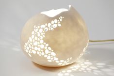 a light that is sitting on top of a table with some lights in the shape of an egg