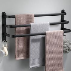 three towels are hanging on a towel rack